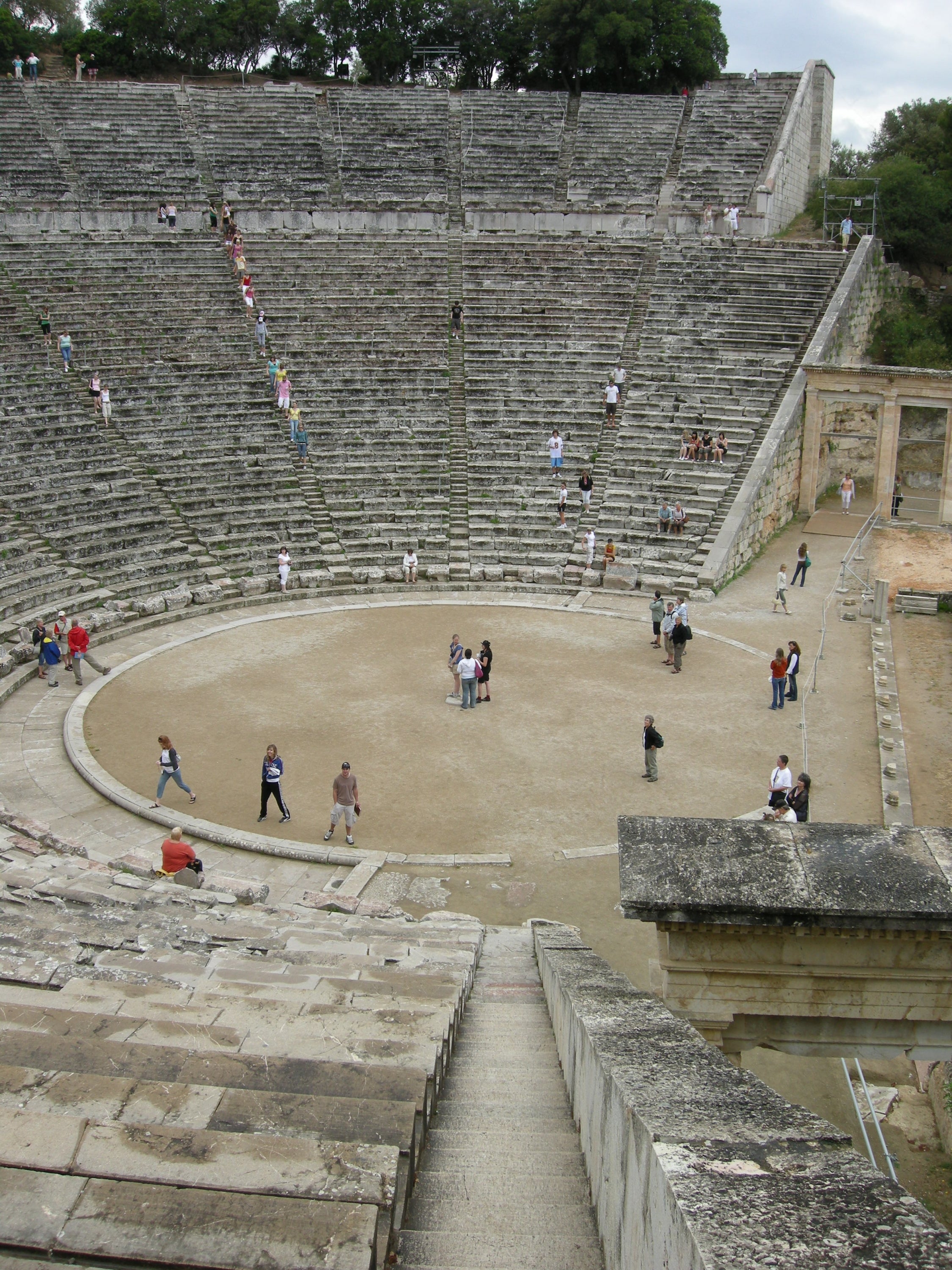 A Roman Ampitheatre showing a large, flat circle centre surrounded by concentric rows of seating, each ring elevated above the previous one