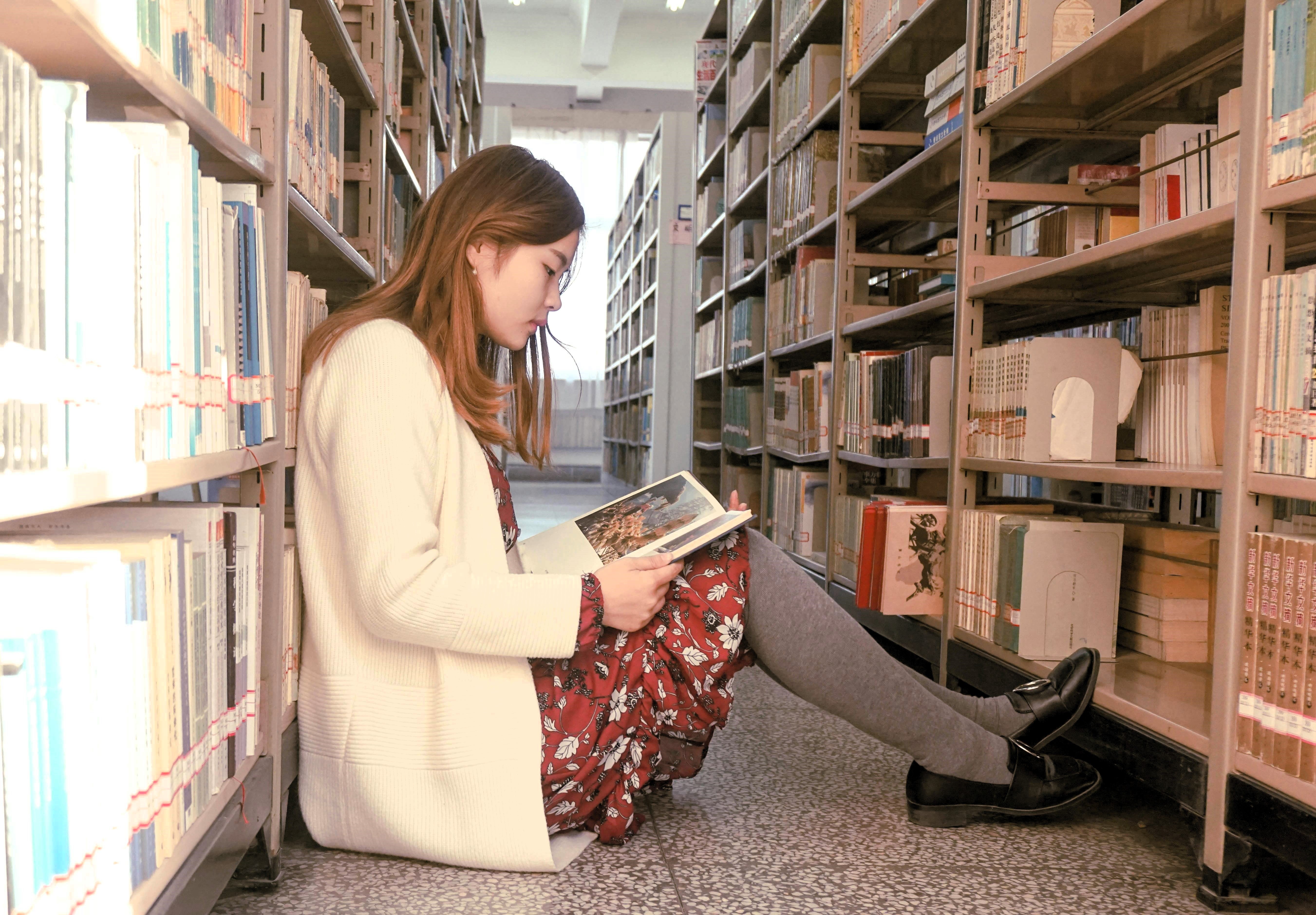 young woman reading in library