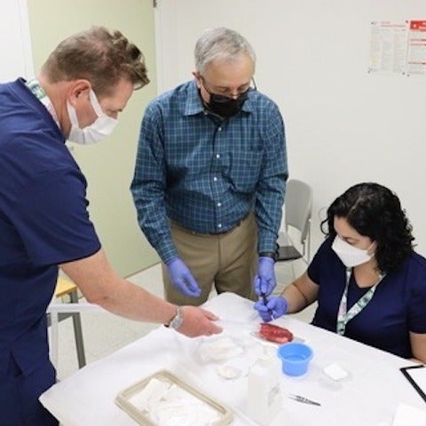 Optometrist teaching techniques to 2 participants 