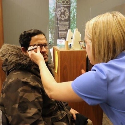 Eye care professional marking patient's glasses
