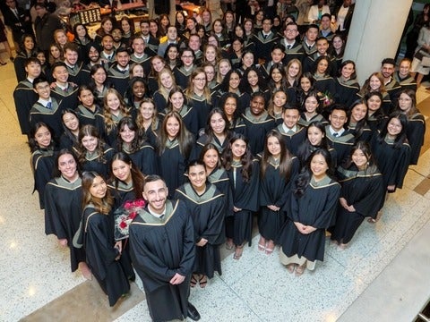 A group of students standing in convocation robes