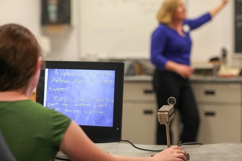 Student views text on a blackboard using a multifunction CCTV.