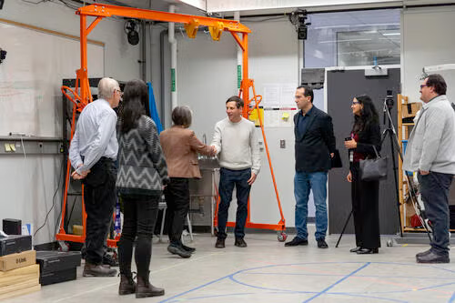 Doug Kavanagh is greeted in a lab by observers.