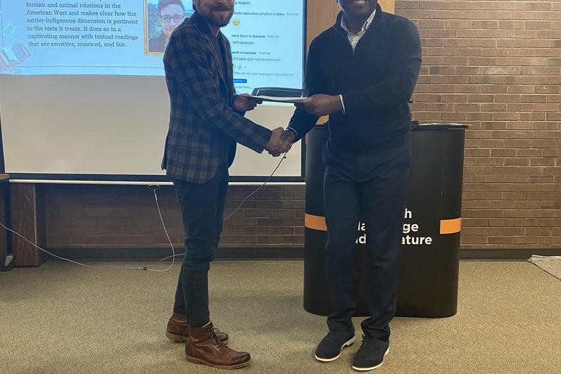 Chris Rogers receives the Beltz Essay Prize, PhD from Dr. Paul Ugor.