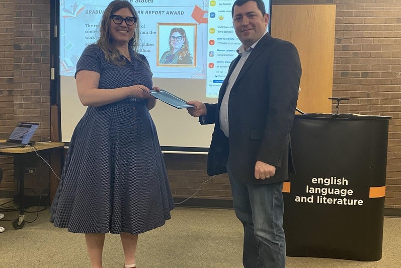 Máire Slater receives the Graduate Co-op Work Report Award  from Dr. John Savarese.