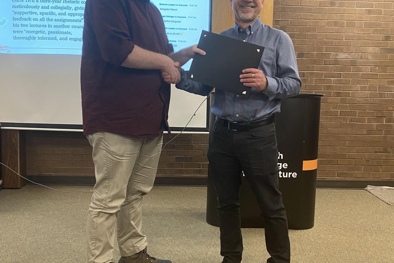 Chris Martin receives the TA Award for Excellence in Teaching  from Dr. Bruce Dadey.
